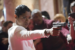 Freda Gatz with gun on red carpet